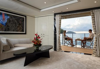 charter guests unwind on the balcony of the VIP suite aboard motor yacht LILI