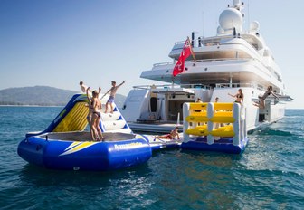 charter guests play on the inflatable water toys on board superyacht TITANIA 