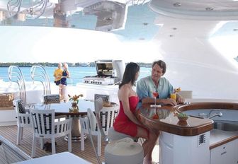 Charter guests socialising on the sundeck of superyacht ALLEGRIA