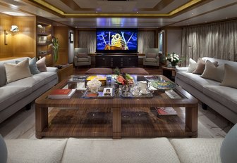 the spacious and modern styled main salon on charter yacht lady britt with grand seating arangement and flat screen tv 