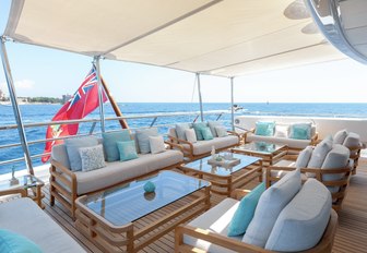 luxe outdoor seating area covered by Bimini shade on board charter yacht La Mirage 