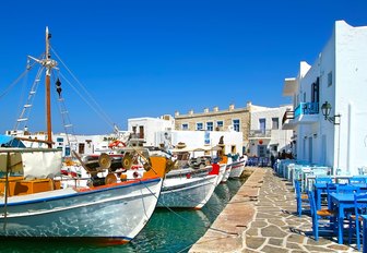 Fishing village in Greece with small boast and white-washed buildings