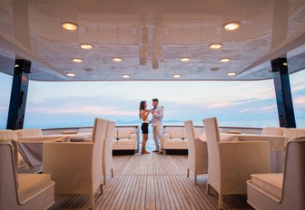 Man and woman enjoying the living area on charter yacht ANDREA