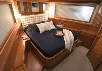 Cosy and relaxing VIP suites on the luxury charter yacht NOMADA surrounded by rich wood furnishings and wide windows 