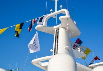 Superyacht with flags draped across it at Monaco Yacht Show 2018