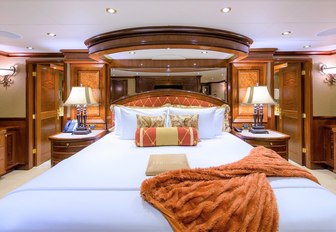 classically-styled master suite with large bed on board superyacht EXCELLENCE