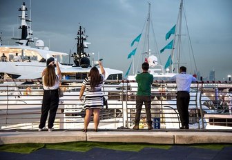 attendees take pictures of the yachts at the Dubai International Boat Show