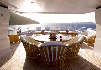 Sun deck and dining area on board luxury yacht HARLE