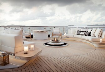 outdoor seating surrounds a fire pit on board charter yacht KISMET