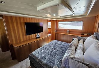 Charter yacht PACHA master cabin with central berth and flatscreen TV