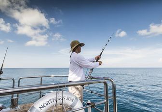 charter guest fishes from swim platform of superyacht ‘Northern Sun’ 