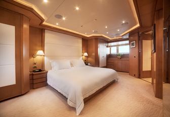 master suite with large bed on board luxury yacht OASIS