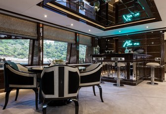 games table and bar in the Art Deco-themed skylounge aboard motor yacht 11/11 