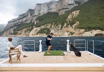 Charter yacht LASATA charter guest using golf facility