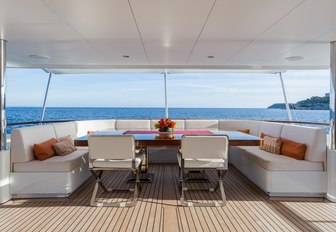 U-shaped sofa and table on the aft deck of motor yacht GO