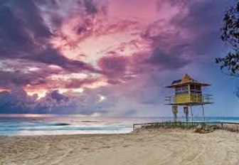 pink sunrise on a deserted sandy beach along the beautiful Gold Coast, Australia