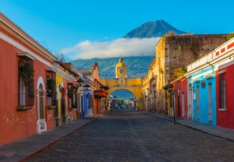 Bright and colourful road in an Antiguan town at the foot of a mountain on a summer day in Antigua 