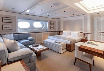 Large cabin with bed and sofas on explorer yacht 'Blue II'