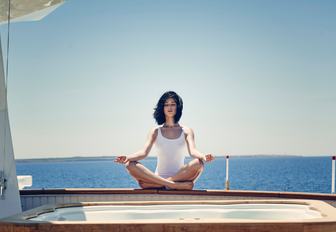 charter guest relaxes by the Jacuzzi on board classic yacht MENORCA