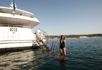 charter guest gets close to the water on swim platform aboard superyacht E&E 