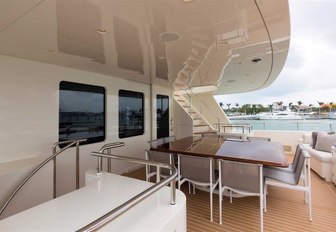 alfresco dining around square table on the upper deck aft of superyacht SAFIRA 