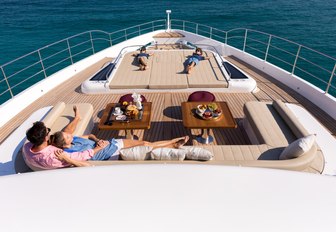 Charter guests gathered together on the foredeck of Gulf Craft superyacht ONEWORLD