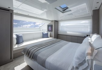 master suite faces large window on board charter yacht Dinaia