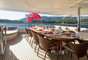 alfresco dining table on the upper deck aft of motor yacht DIANE 