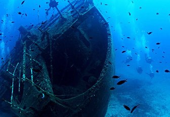 Scuba divers examine a shipwreck in Greece