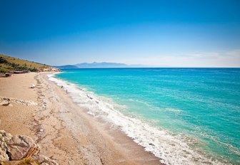 A deserted sandy beach and blue sea