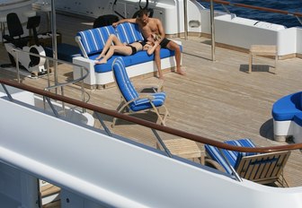 Man and woman enjoy sundeck seating on charter yacht Lady Ellen II