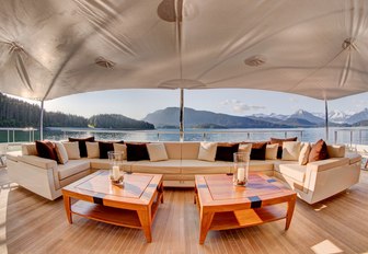 Ivory coloured sofa forms alfresco lounge on main deck aft of charter yacht Party Girl