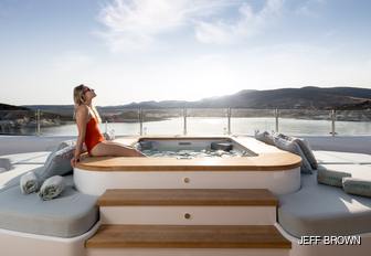 Young lady in pool with amazing views behind on O'PARI