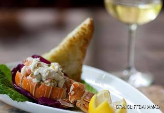 Graycliff Bahamas lobster dish with glass of white wine