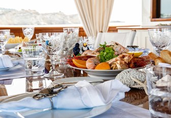 Close up shot of breakfast spread on the dining table of a luxury charter yacht