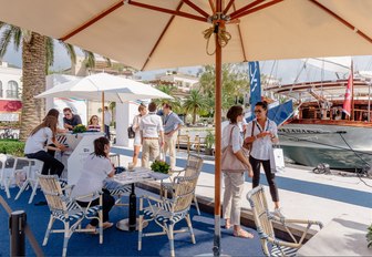 attendees stop for a chat under the shade at the MYBA Pop-Up Show