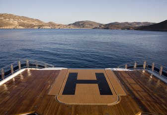 wide shot of glass bottom swimming pool of charter yacht Alfa Nero whose platform has been raised to turn the space into a helipad 