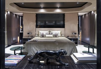 modern-styled master suite with large bed and panther statue on board superyacht SOLO 