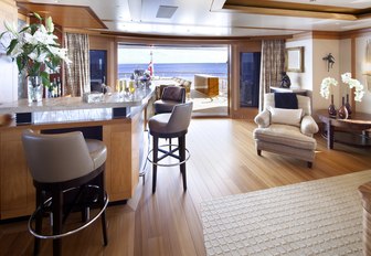 the sophisticated and airy upper lounge of charter yacht lady britt with cocktail bar and lounging space perfect for hosting social gatherings