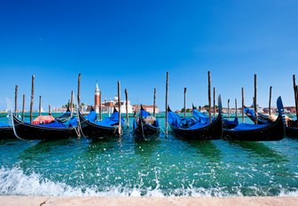 gondolas line up along the Grand Canal in Venice, Italy