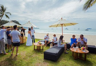 guests gather for drinks beachside at the Kata Rocks Superyacht Rendezvous 