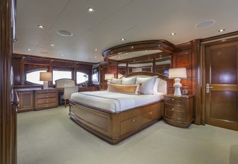 large bed in the centre of the full-beam master suite aboard charter yacht Far From It 