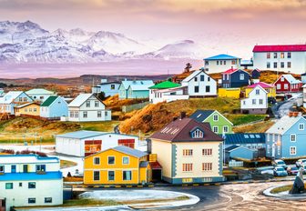 pastel village in iceland close to mountains