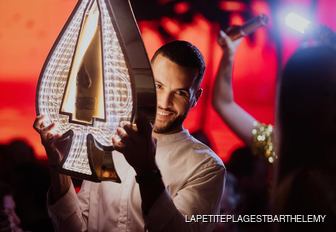 Waiter at La Petite Plage delivering champagne