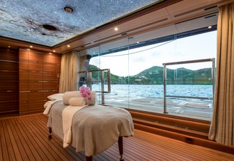 Charter yacht BLACK PEARL massage room with table adjacent to large window