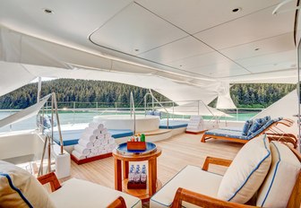 sundeck and jacuzzi on superyacht party girl, with towels and little coffee table