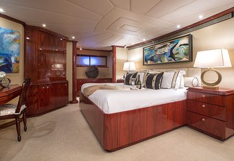 master suite decorated in rich woods aboard charter yacht Sweet Escape 