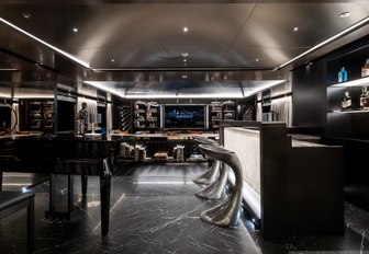 bar, piano and seating area in the skylounge aboard charter yacht SOLO 