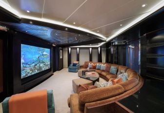Luxury yacht charter WHISPER interior cinema room with curved sofa