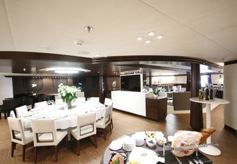 circular dining table in main salon of motor yacht KATINA 